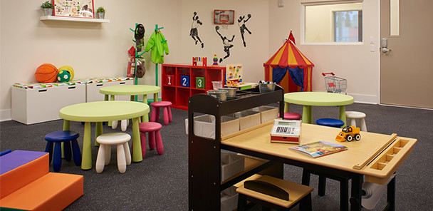 Play room for children with seating areas, activity zones, and toys.